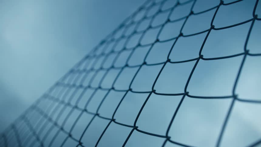 The chain link fence reaches the sky