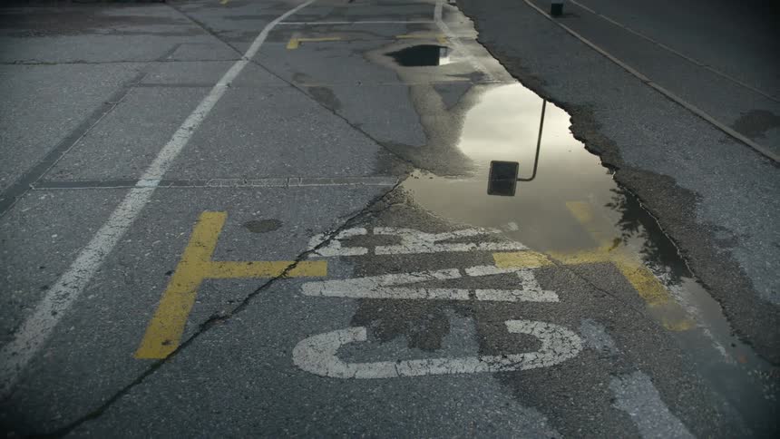 A view of a puddle in the middle of a road