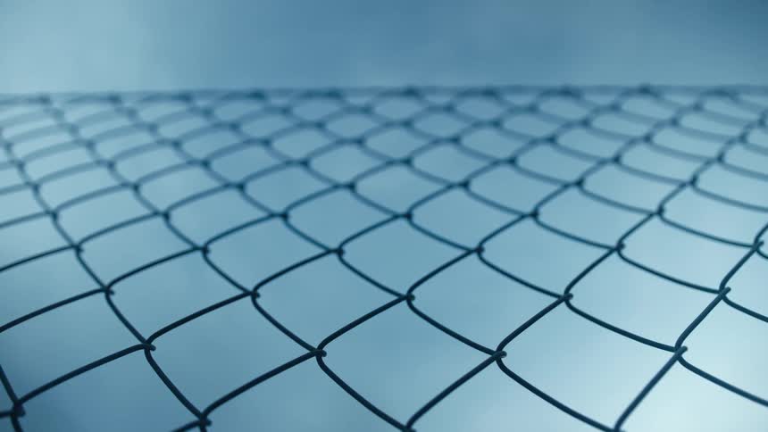 Chain link fence with a blue sky in the background