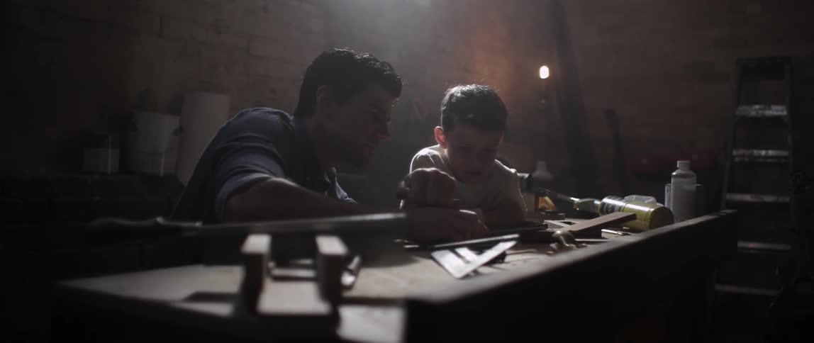 Man and boy working together in a shop