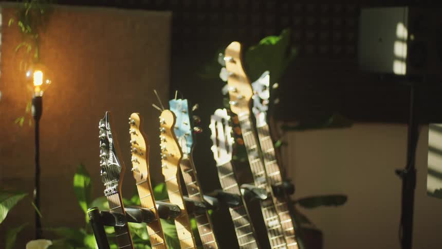 A row of guitars inside a building