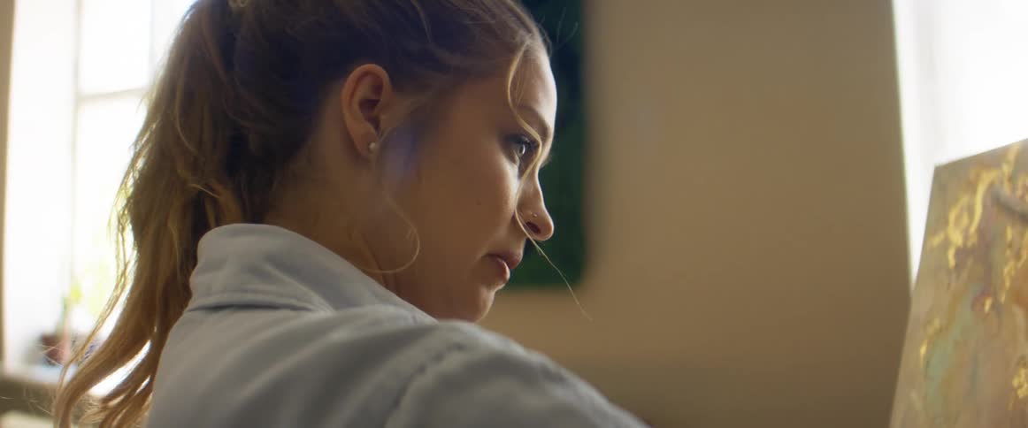 A woman painting on a canvas