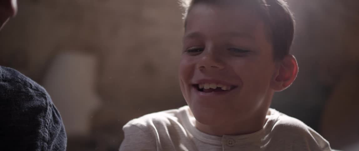 A child is laughing and smiling