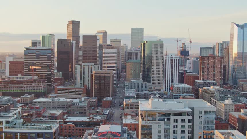 Aerial view of high rise buildings and city streets at dawn