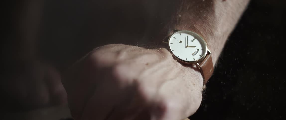A man wearing a watch turns his wrist
