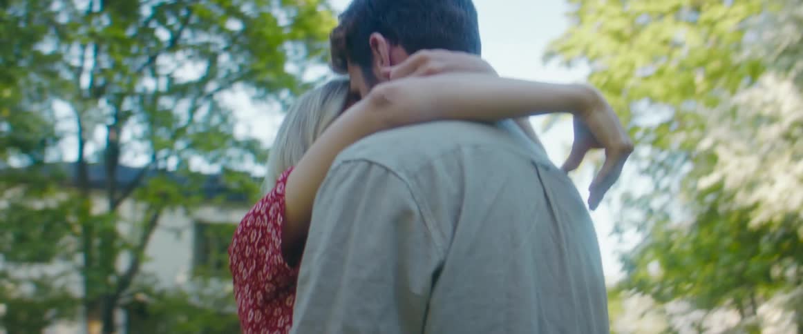 Young couple hugging and kissing on the backyard at home