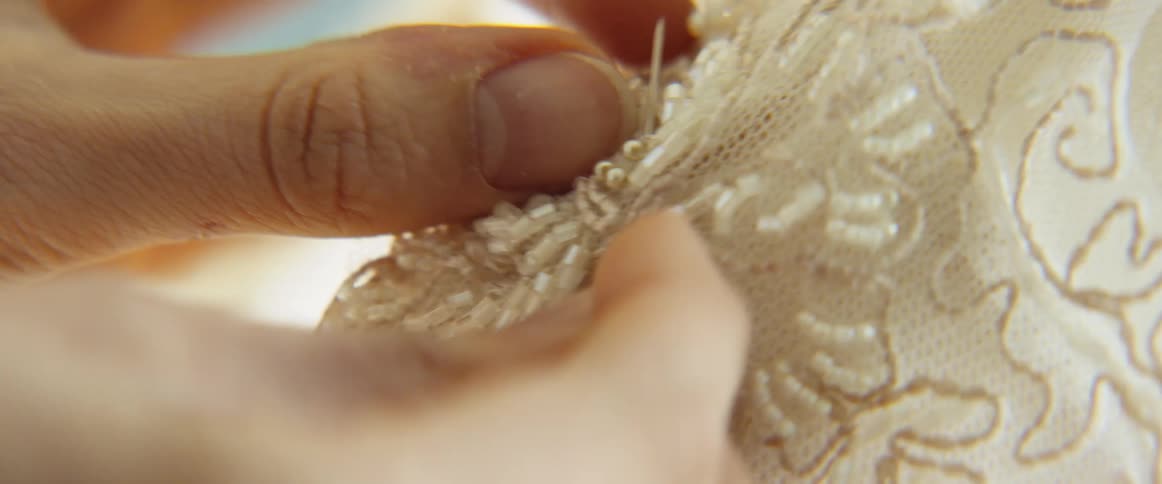 Woman secures a piece of clothing with a pin