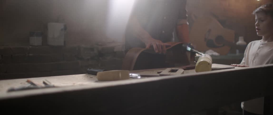 A man is working a piece of wood on a machine