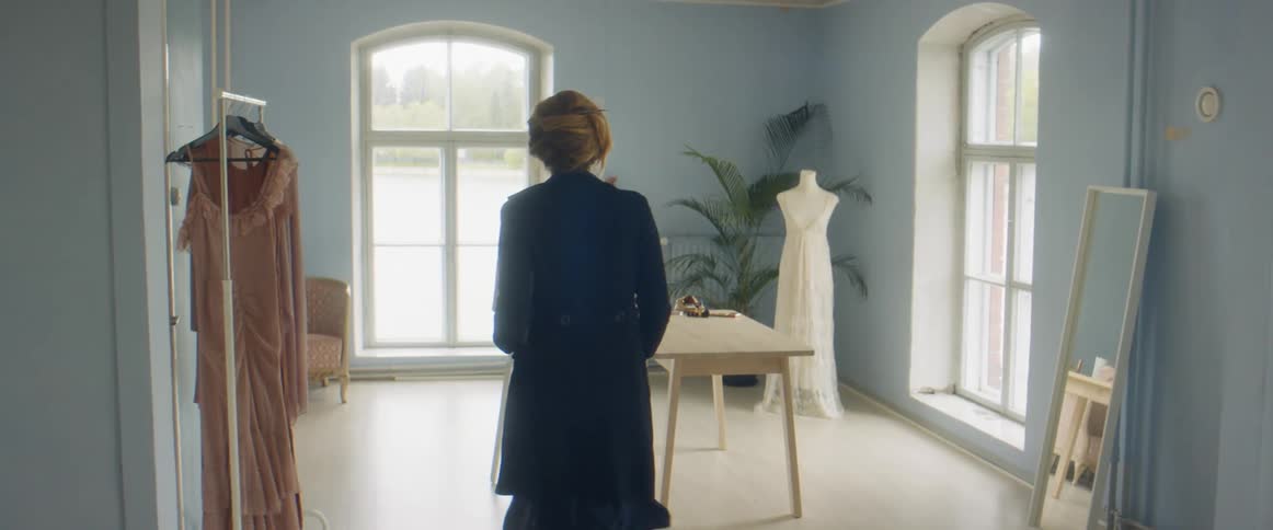 A woman is walking around a room during the day
