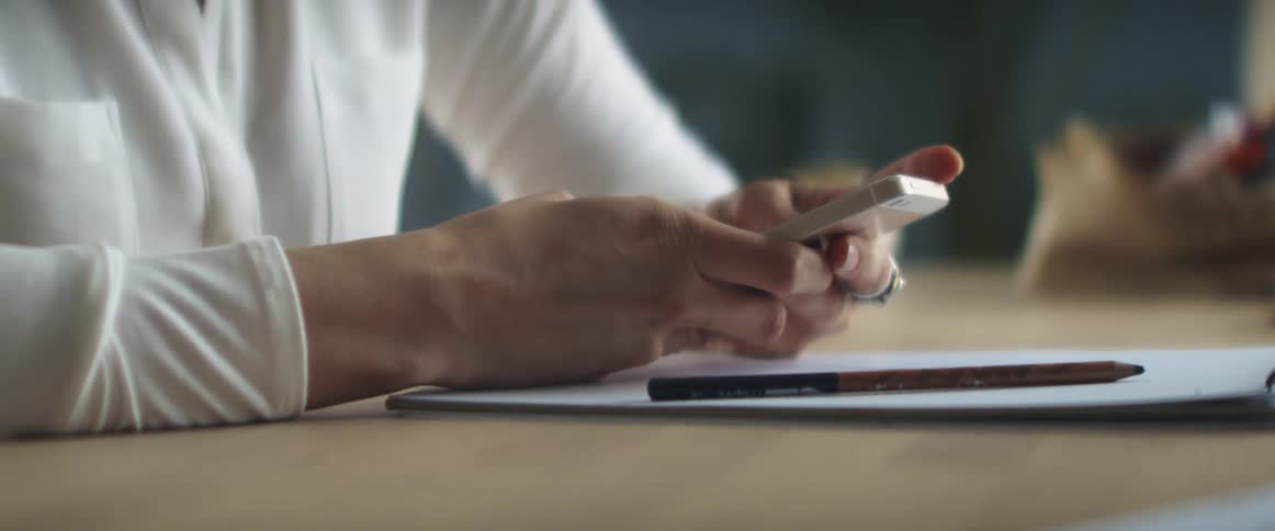 A woman picks up her phone and types on it