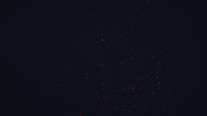 Embers are flying above a burning flame