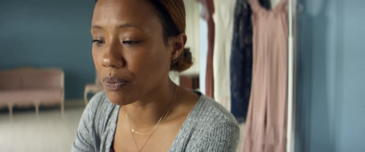 A woman in a shop talks
