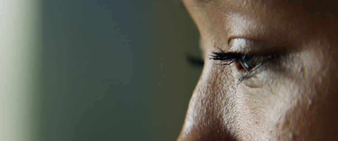 Light reflects on a womans skin as she blinks