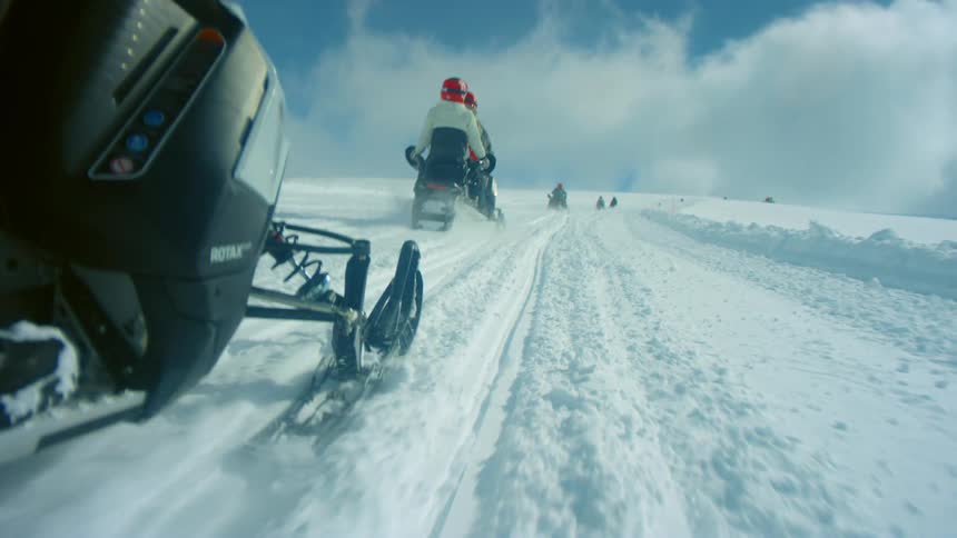 Shot of a snowmobile going up a hill