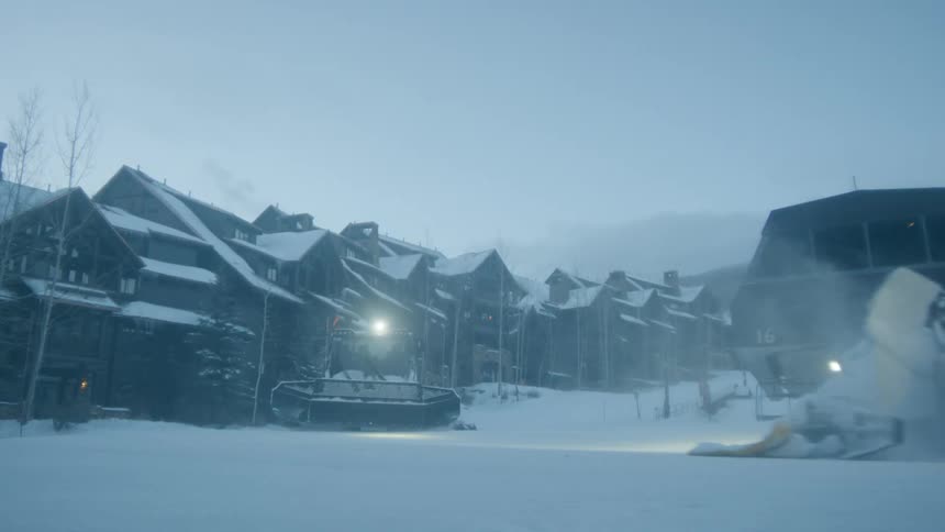 Large snow plows clear the resort area