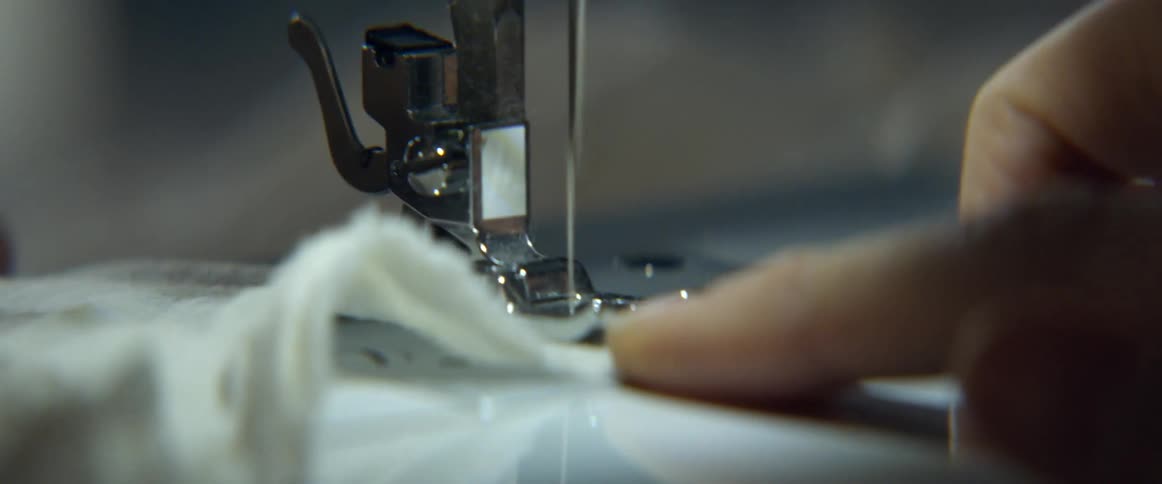 Fabric is being fed through a sewing machine