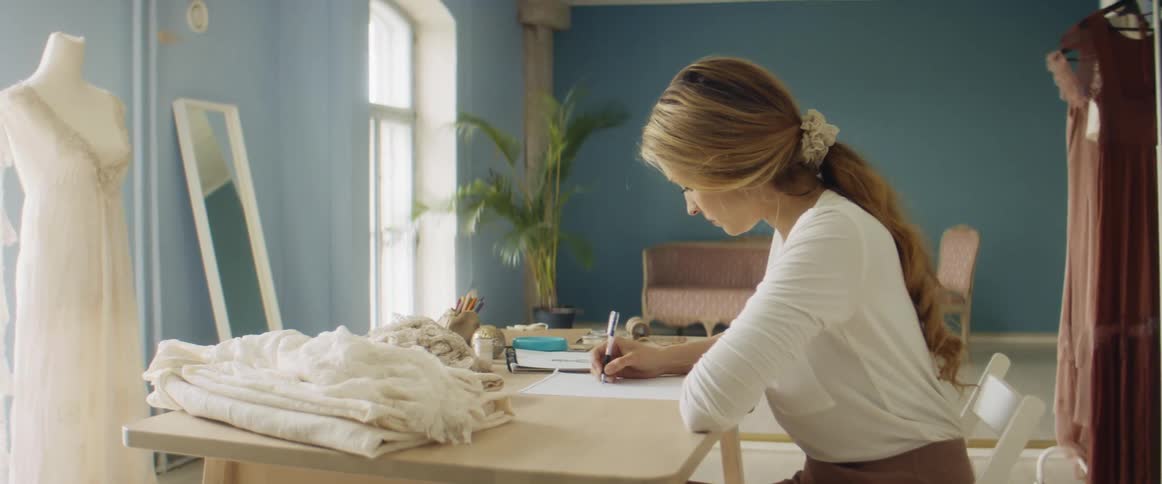 A woman drawing on a piece of paper