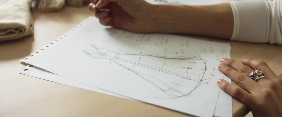 A woman sketching a piece of clothing