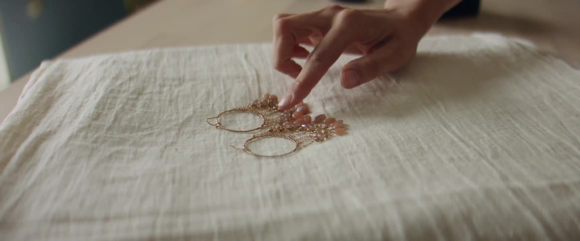 A person is examining some jewelry