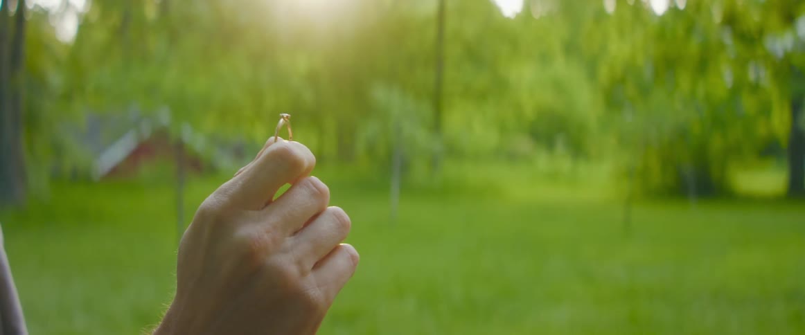 A person holding up a ring