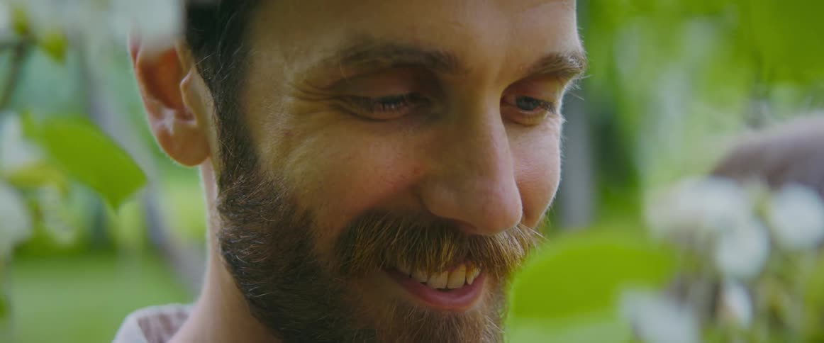 A man smiles as he looks at a woman
