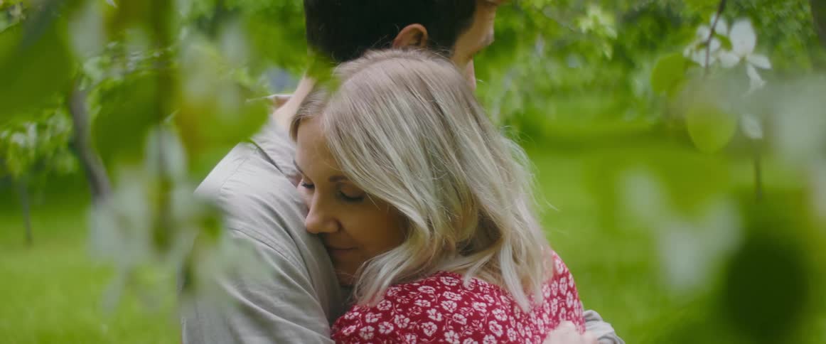 A man and woman hugging outside