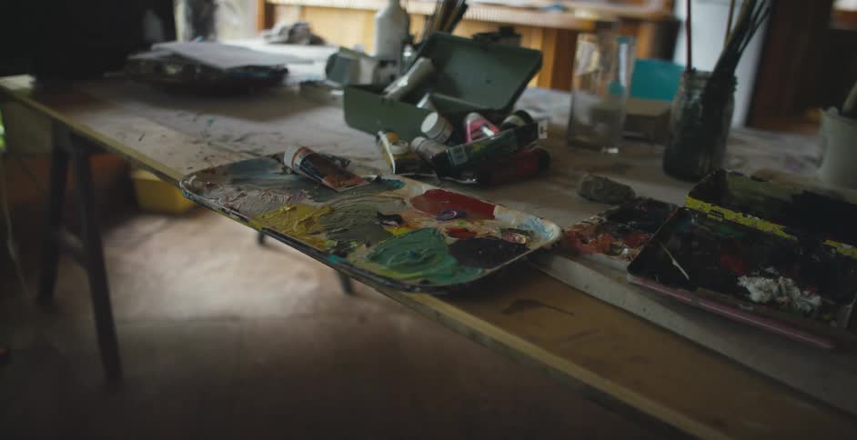 A view of paints on a pallet sitting on a table