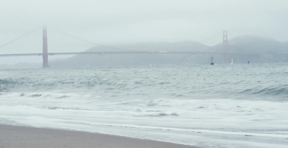 Strong waves hitting the short as a bridge can be seen in the background