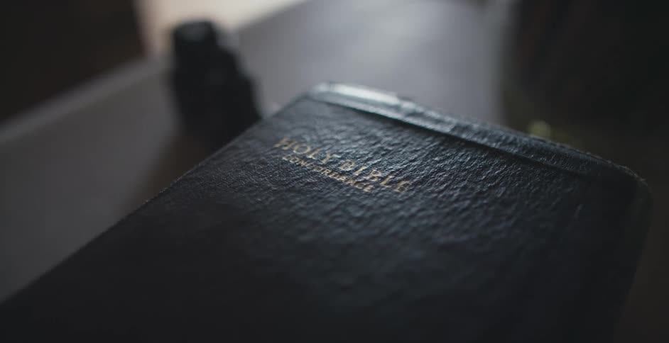 The holy bible on a table in a room