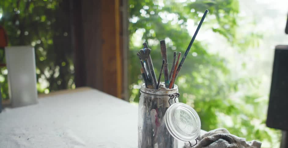 Paint brushes are displayed on a table