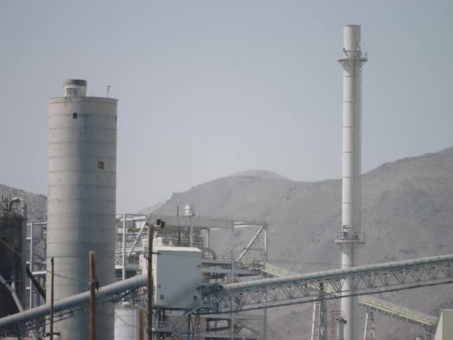 A view of a factory with towers outdoors