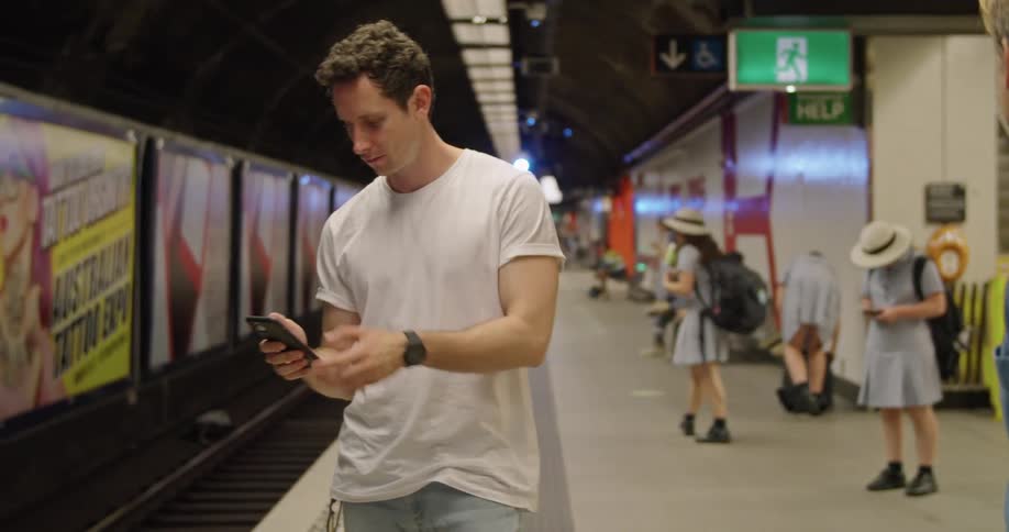 A man on his phone in a subway station