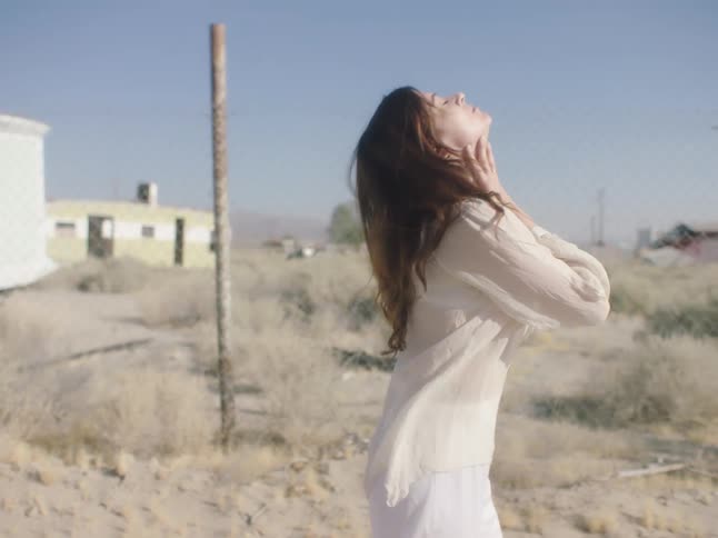 A woman stumbles in the desert