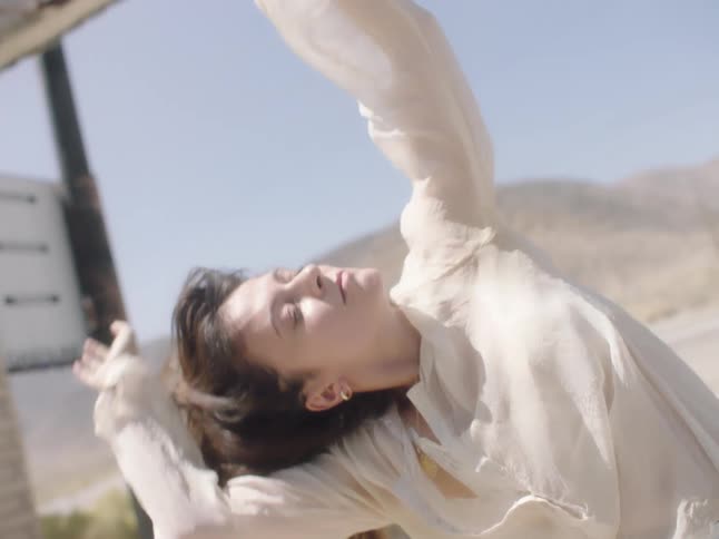 A woman dancing in a desert