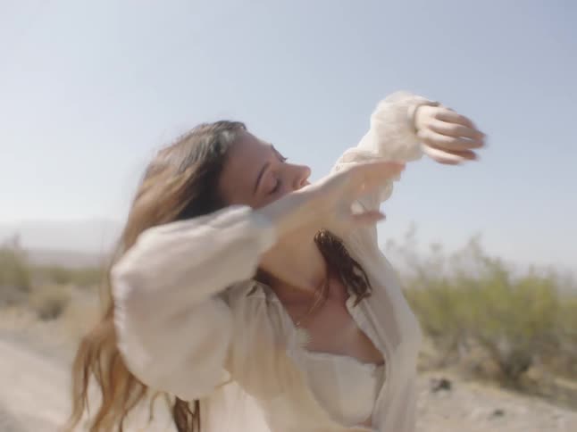 A woman dancing in a desert