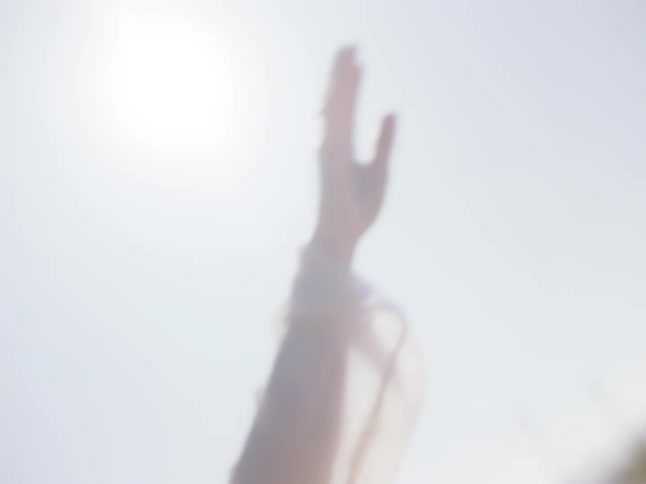 Woman dances outside on a sunny day