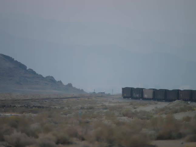 Wide shot of a rural area with railroad tracks