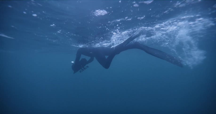 A diver records footage underwater