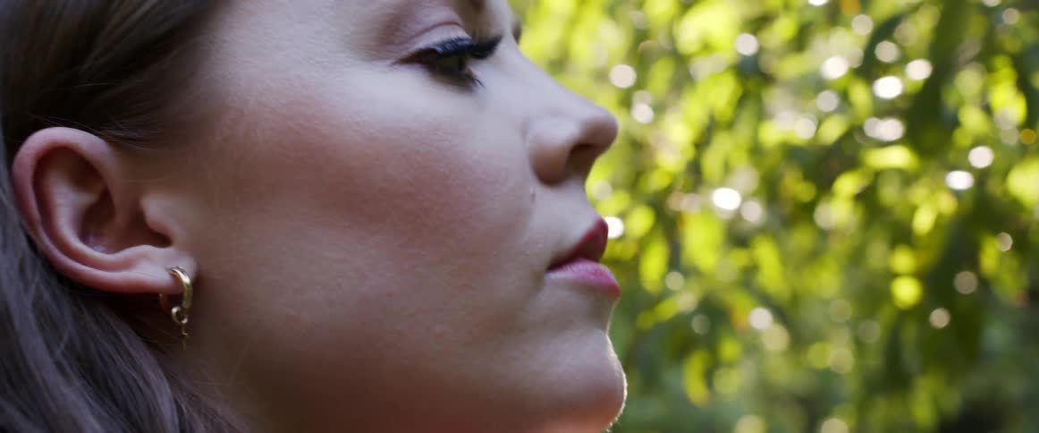 A woman looking around in the forest