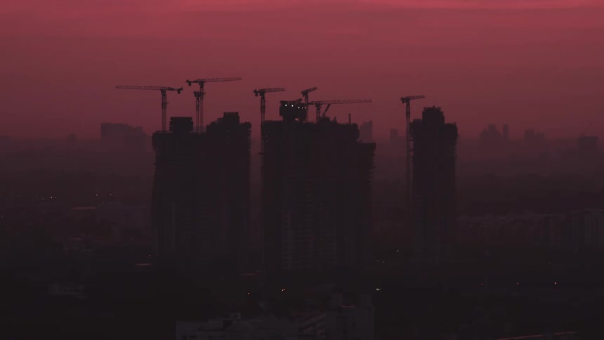 A time lapse of a building with cranes