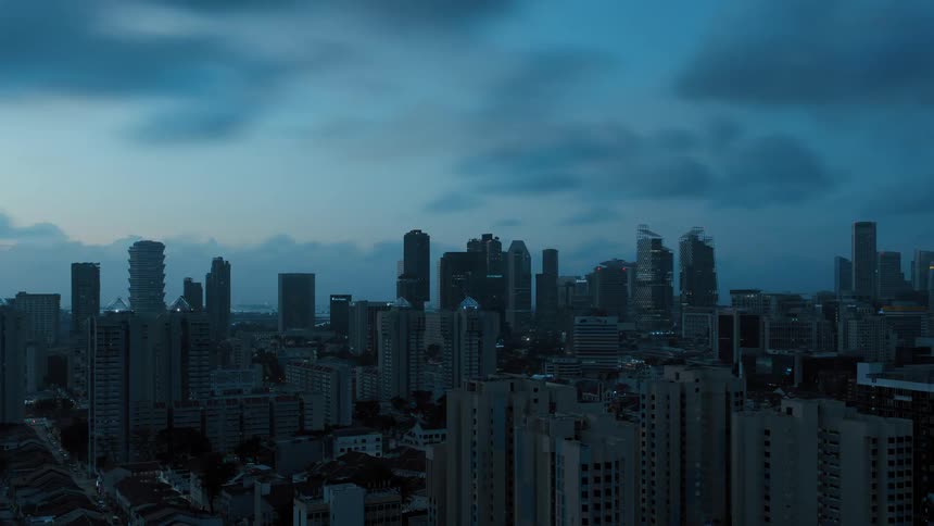 Sky changes from red sky through pale blue then dark blue as city lights darken and brighten
