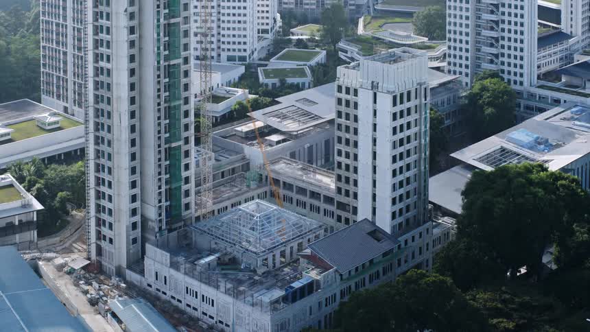 Multiple high rise sections of a downtown building are simultaneously built