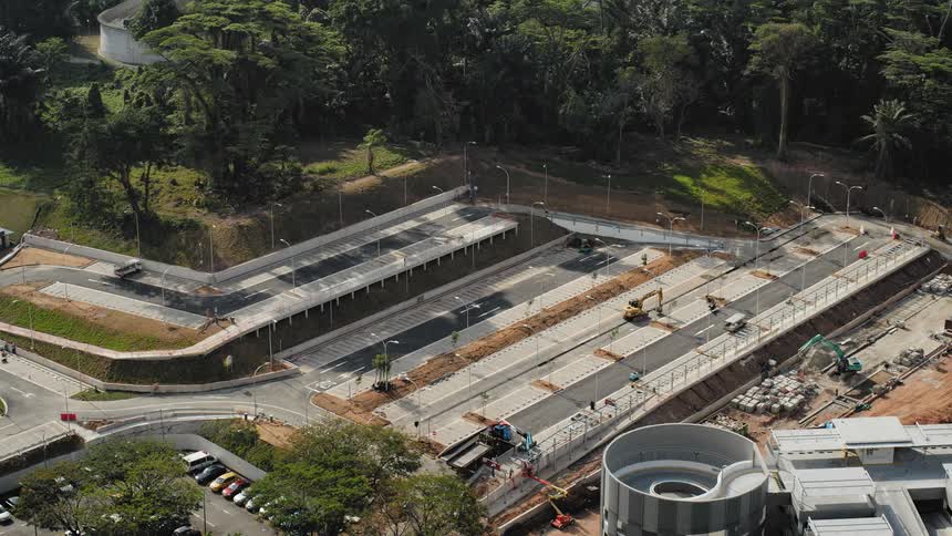 Time lapse of a construction crew building a parking lot and then cars parked when it is complete