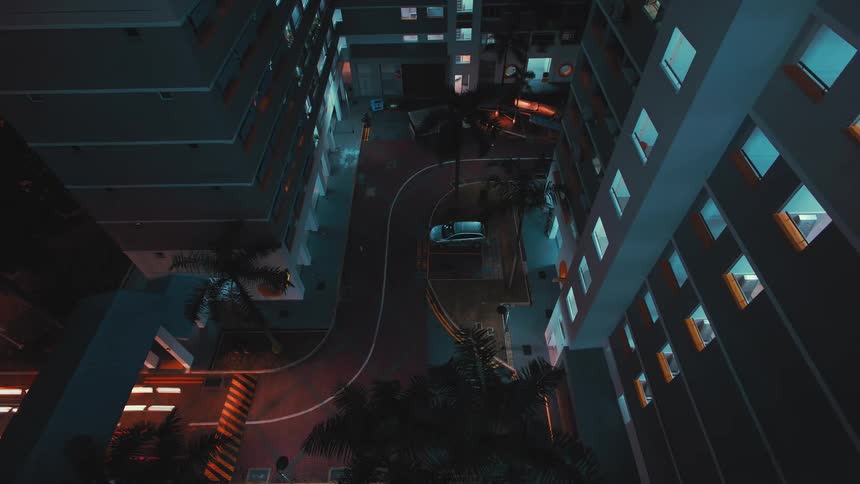 Time lapse of vehicles driving on the city street leaving a trace of light behind at night