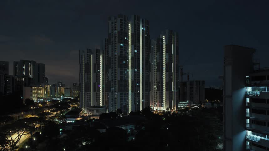 A city with buildings and trees with the sky and clouds in the background