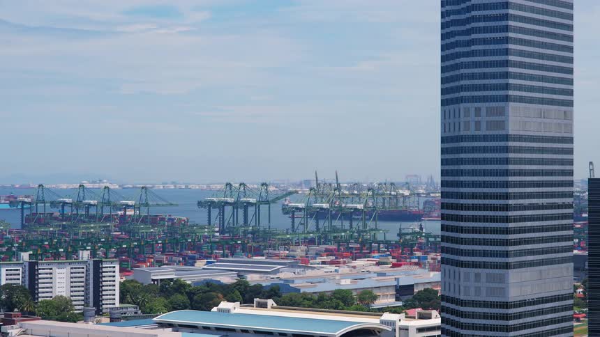 Time lapse of vehicles moving shipping containers on the shore