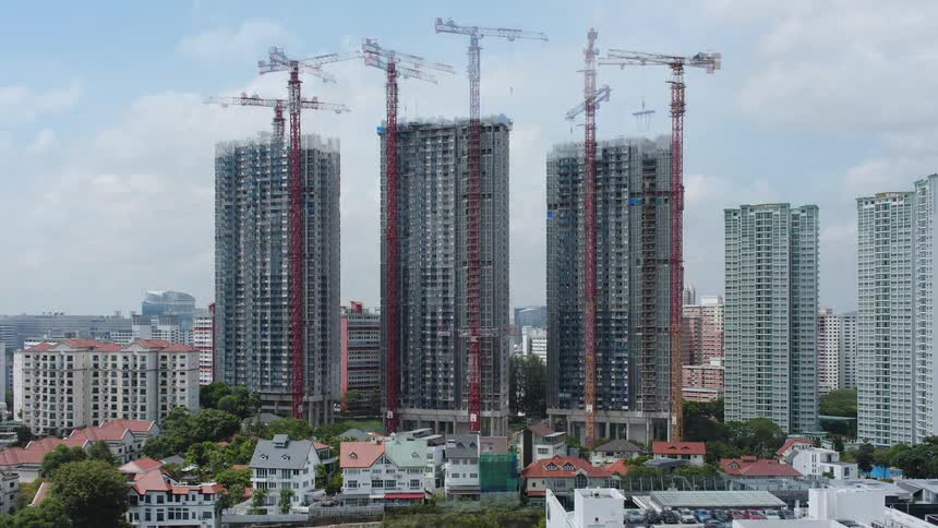 Three tall buildings are constructed in a large city