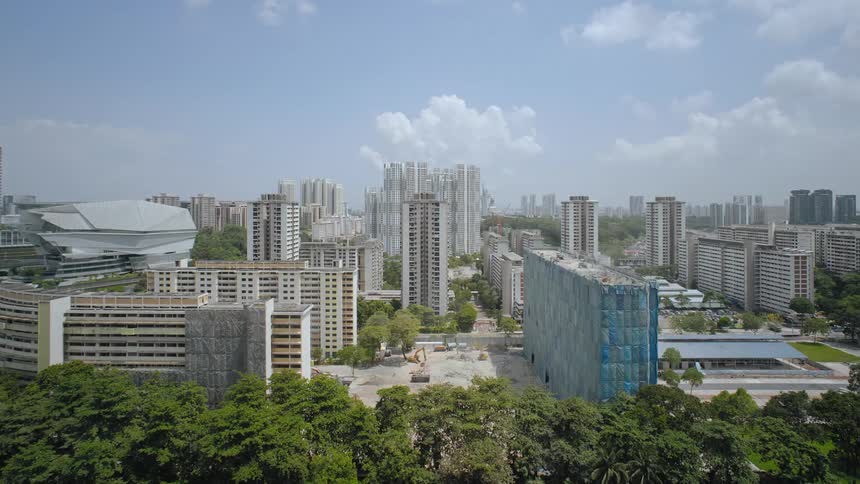 Buildings disappear as construction flows in reverse in city bordered by trees