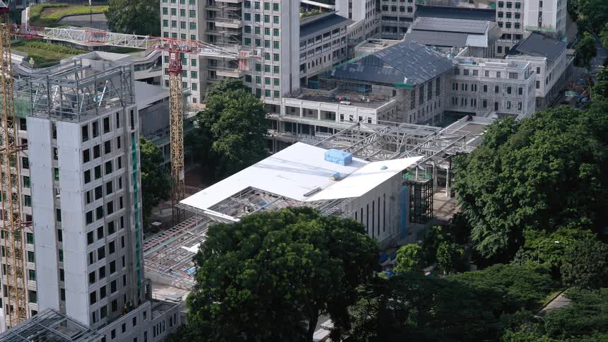 Construction crews work on multiple buildings of varying sizes downtown