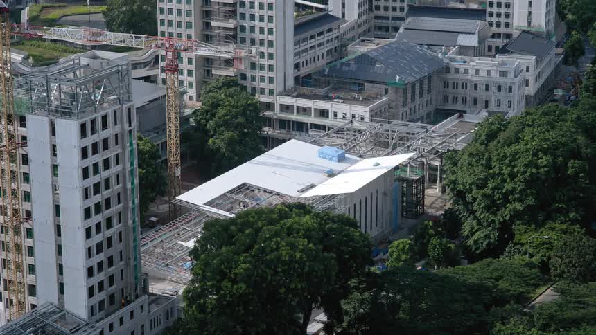 A group of buildings being constructed in a city during the day